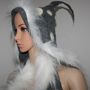 May include: A gray hooded scarf with white faux fur trim and white polka dots. The hood has a long, pointed tip.