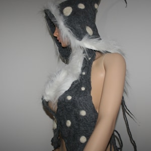 May include: A gray hooded garment with white fur trim and white polka dots. The garment is made of a soft, fuzzy material and has a long, flowing design.