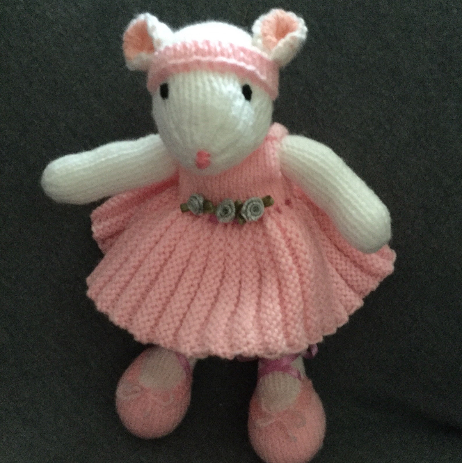 darcey the dancing toy mouse. she wears a pink ballet dress and bright pink ballet shoes . she is safe and soft.