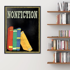 May include: A framed art print with the word "NONFICTION" in green lettering. The artwork features a black background with colorful book spines in red, green, blue, and yellow. Bookshelves filled with books are in the background.