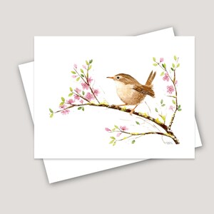 May include: A watercolor painting of a brown wren perched on a branch with pink blossoms. The bird is facing left and has its wings folded. The branch is covered in green moss.