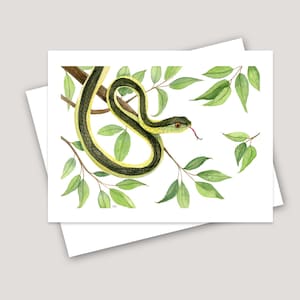 May include: Watercolor painting of a green and yellow snake with a red tongue curled around a branch with green leaves.
