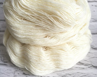 May include: A ball of white yarn, wound into a skein.