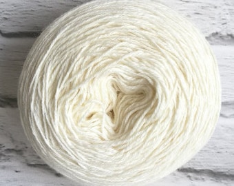 May include: A ball of white yarn, wound into a tight coil. The yarn is soft and fluffy, and it is perfect for knitting or crocheting.
