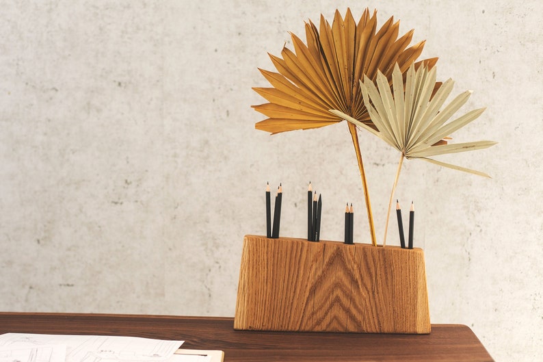 Modern wooden pen holder with beautiful design and look on a desk