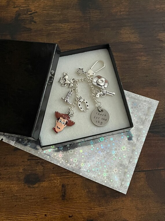 Toy Story Disney Film Inspired Woody Key Ring Charm Set Reach For The Sky Hat Badge Horse Cowboy Themed Gift Boxed Shimmer Bag Quirky