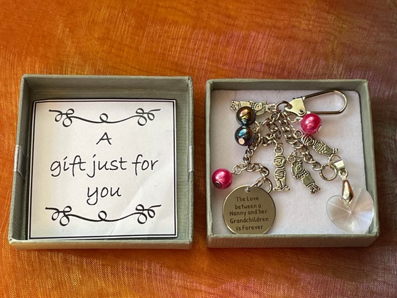 The love between a nanny and her grandchildren is forever keepsake charm with a choice of amount of grandchildren added beads heart boxed