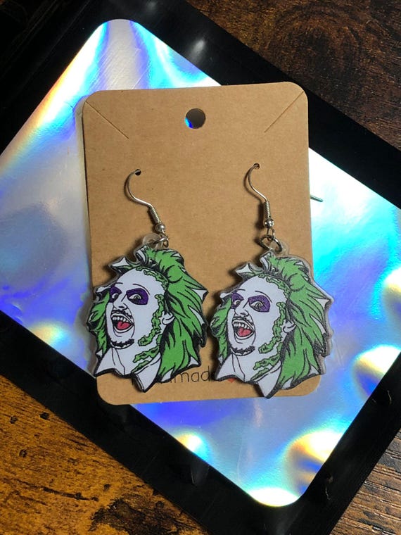 BEETLE JUICE Film Inspired Pair Of Earrings Fun Novelty Quirky Gift Secret Santa Stocking Filler New Film Dangling Acrylic Head Shimmer Bag