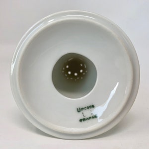 May include: White ceramic strainer with a green inscription that reads " Limoges France".