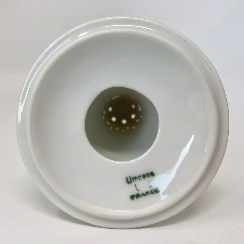 May include: White ceramic strainer with a green inscription that reads " Limoges France".