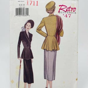 May include: Vintage Butterick sewing pattern, style 6256, featuring a retro design from 1947. The pattern includes illustrations of a woman in a suit and a woman in a jacket and skirt. The pattern is in shades of black, yellow, and pink.