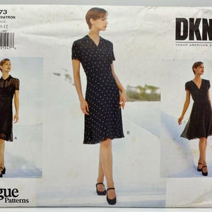 May include: A vintage Vogue Patterns sewing pattern featuring three DKNY dress designs. The pattern includes sizes 8-10-12. The dresses are black, with short sleeves and various design details, including polka dots and lace.