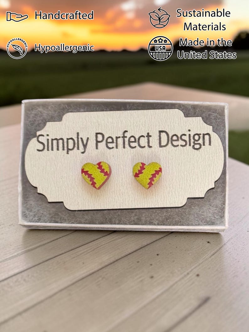 Softball heart studs on a card in a gift box at sunset