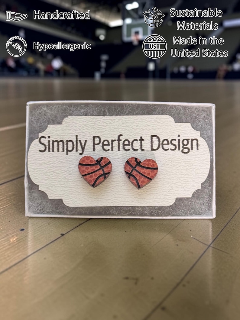 Basketball heart studs on a card in a gift box in a gym
