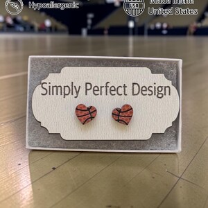 Basketball heart stud earrings on a card in a gift box on a court