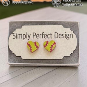 Yellow softball heart studs on a card in a gift box