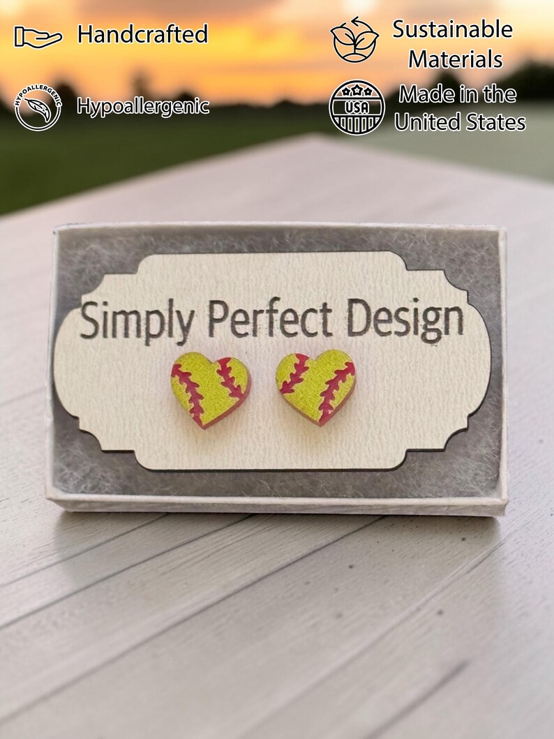 Yellow softball heart studs on a card in a gift box
