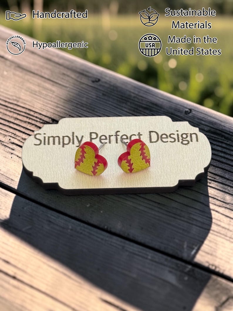 Softball heart stud earrings on a card outdoors