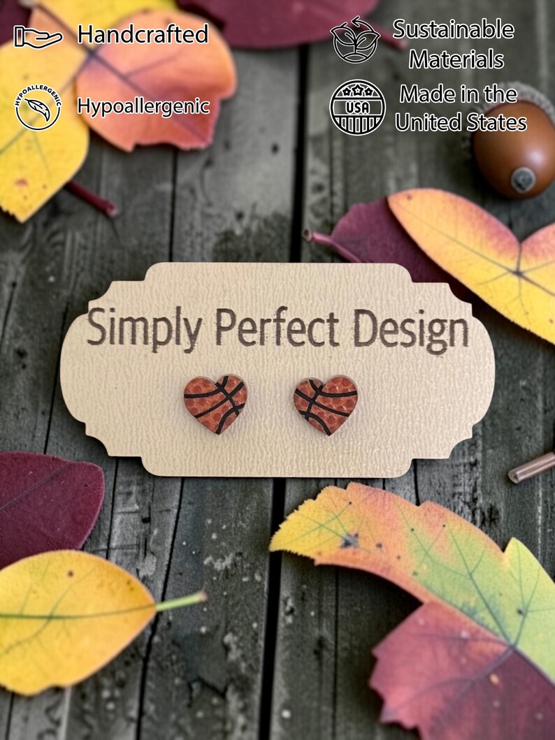 Heart shaped basketball studs on a card on a wood table with leaves