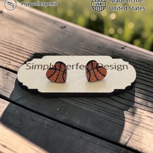 Basketball heart studs on a card on a wood bench