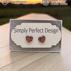 Basketball heart studs on a card in a gift box at sunset
