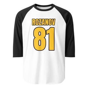 May include: White and black baseball style shirt with the name "ROZANOV" in yellow block letters above the number "81" in yellow. The shirt has black sleeves and a white body.