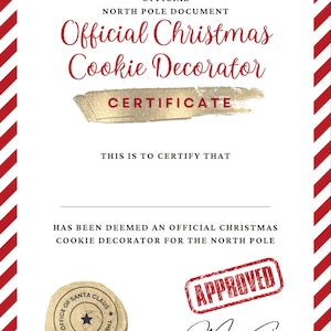 May include: A red and white striped certificate with gold text that reads "Official Christmas Cookie Decorator Certificate". The certificate is signed by "Mrs. Claus" and stamped "Approved" with a gold seal that reads "Office of Santa Claus, The North Pole".