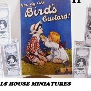 May include: A set of miniature dollhouse boxes with the text "Bird's Custard" printed on them. The boxes are white with black lettering and illustrations. The boxes are arranged in a row on a table. There is a larger box in the background with the same text and a colorful illustration of two children.