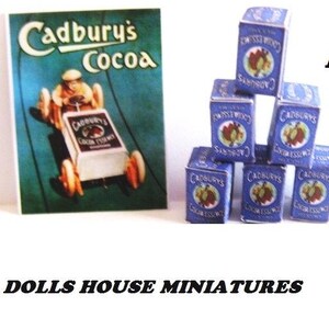 May include: A stack of six miniature boxes of Cadbury's Cocoa Essence. The boxes are blue with white lettering and a picture of a cocoa bean. The boxes are stacked in a pyramid shape. The image also includes a vintage advertisement for Cadbury's Cocoa.