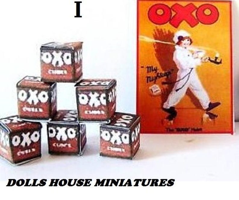 May include: A set of six miniature boxes, each with the word "OXO" printed on the front. The boxes are stacked in a pyramid shape. The boxes are brown and white and have a vintage look. The boxes are a miniature replica of the classic OXO brand.