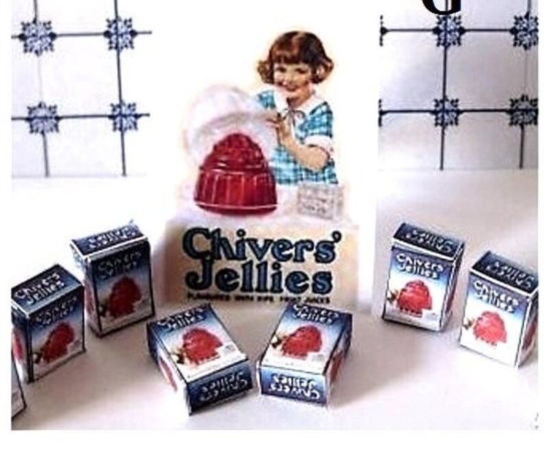 May include: A miniature set of six boxes of Chivers Jellies, a brand of jelly desserts. The boxes are blue and white with red and white illustrations of jelly desserts. The boxes are arranged in a semi-circle on a white surface. The boxes are labeled "Chivers Jellies".