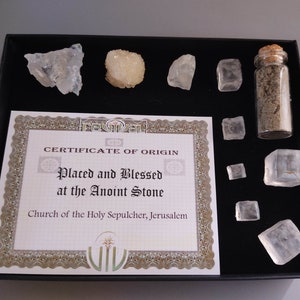 May include: A black box containing a certificate of origin for salt placed and blessed at the Anoint Stone in the Church of the Holy Sepulcher, Jerusalem. The box also contains a small glass vial of salt and several clear salt crystals.