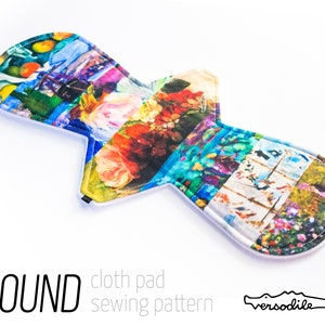 May include: A colorful round cloth pad sewing pattern with a white background. The pattern features a variety of images, including flowers, fruit, and landscapes. The text "ROUND cloth pad sewing pattern" is printed below the pattern. The text "versodille" is printed below the text.