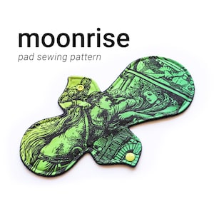 May include: A green and black reusable cloth pad with a vintage illustration of a woman riding a horse. The pad has yellow snaps on the sides. The text "moonrise pad sewing pattern" is printed above the pad.