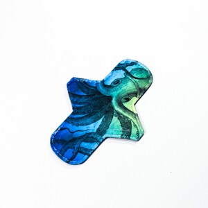 May include: A blue and green reusable cloth pad with an octopus print.