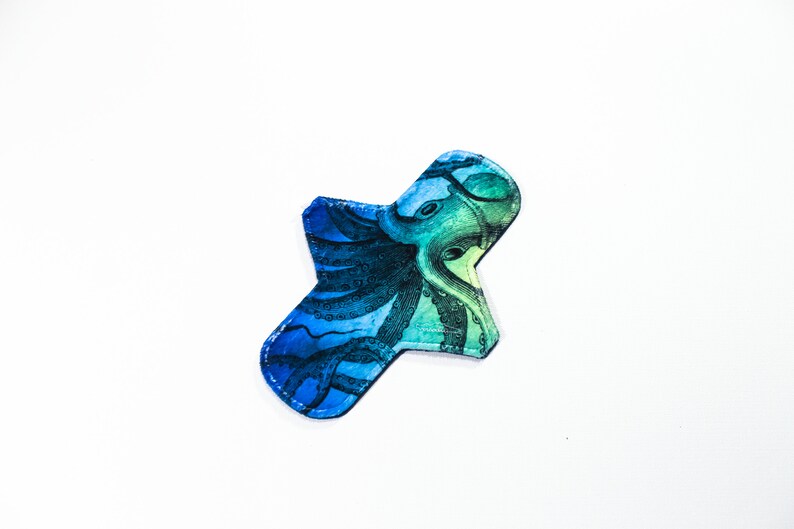 May include: A blue and green reusable cloth pad with an octopus print.