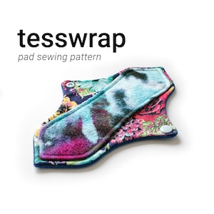 May include: A reusable cloth pad with a floral print on one side and a blue and purple tie-dye print on the other side. The pad has a blue trim and two white snaps.