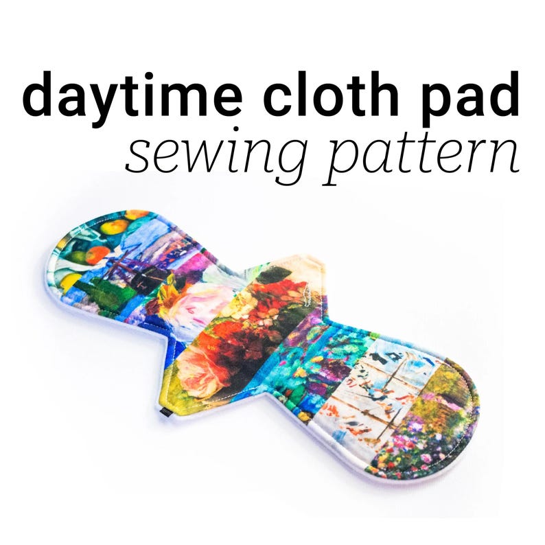 May include: A colorful cloth pad sewing pattern with a floral and geometric print. The pad is made of fabric and has a white border.