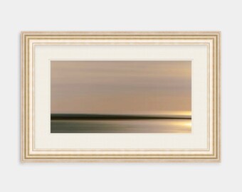 May include: A framed abstract landscape painting with a muted color palette of beige, brown, and gray. The painting depicts a blurred horizon with a subtle glow of light in the distance.