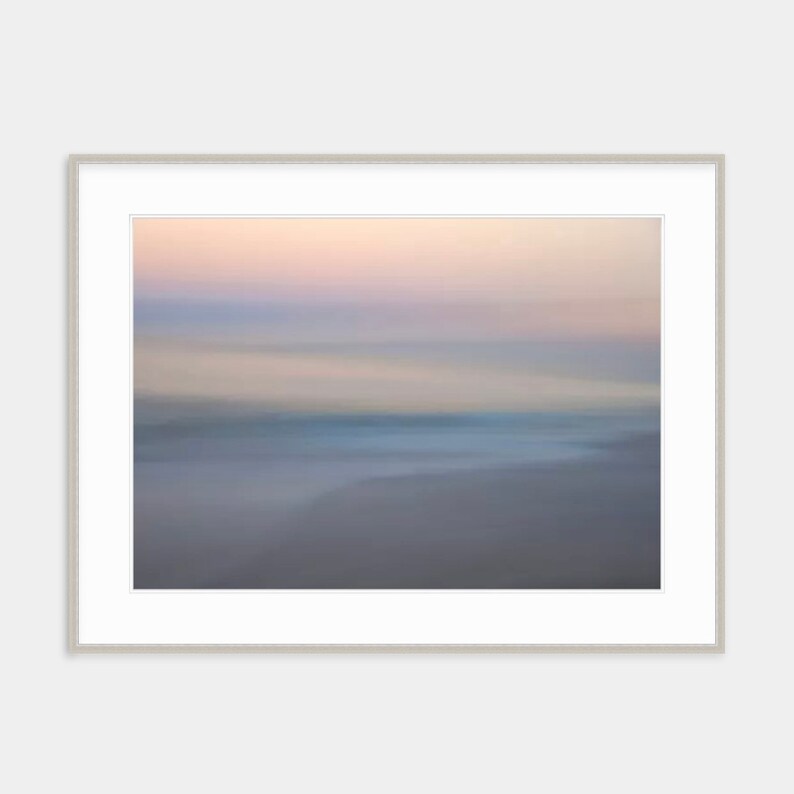May include: Abstract art print featuring a blurred, dreamy landscape with soft pink, blue, and gray hues. The image evokes a sense of calm and tranquility.
