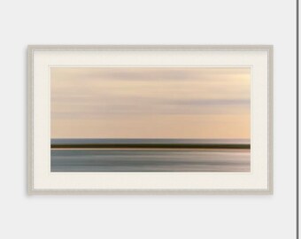 May include: A framed abstract landscape photograph with a blurred horizon of a beach and sky in shades of beige, brown, and blue.