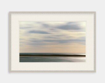May include: A framed photograph of a blurred seascape with a light blue sky and a dark blue ocean. The horizon is visible in the distance.