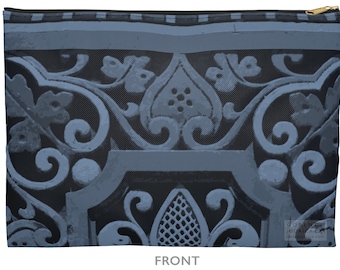 May include: A blue zippered pouch featuring a detailed, ornate design. The pattern includes floral and scrollwork elements in shades of blue and gray. The word "FRONT" is printed at the bottom.