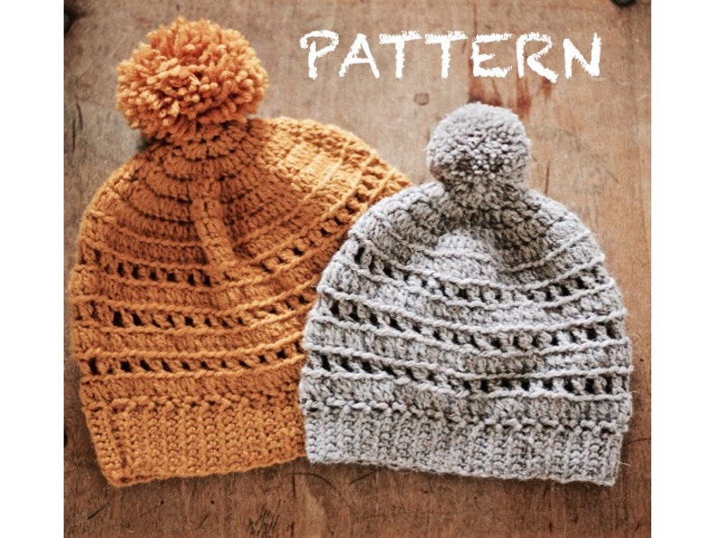 May include: Two crocheted hats with pom-poms. The hat on the left is mustard yellow and the hat on the right is gray.