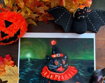 May include: A black cat wearing a red and white clown costume with a red nose and a black hat with a white star. The cat is floating in a dark green sea with a bright white moon in the background. The image is a painting.