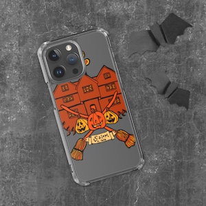 Pode incluir: Uma capa transparente para telefone com um design temático de Halloween. O design apresenta uma casa vermelha e laranja com um chapéu de bruxa no topo, cercada por abóboras e vassouras. O texto "Salem, 1630" está impresso na capa.