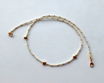 thin beaded choker with tiny hearts of gold