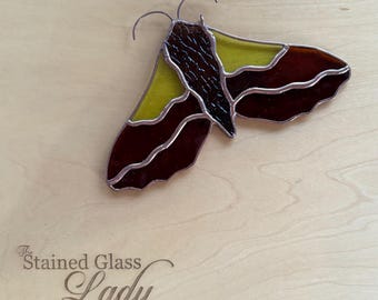 Handcrafted stained glass moth suncatcher in plum, green, and brown, unique window or wall hanging