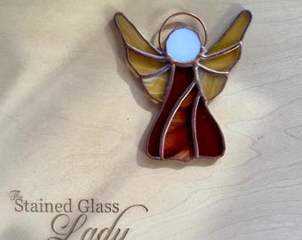 Handcrafted stained glass angel ornament in deep red and gold