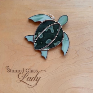 Handcrafted stained glass sea turtle suncatcher in dark green and light green mottled, beachy home decor, coastal gift idea, window hanging